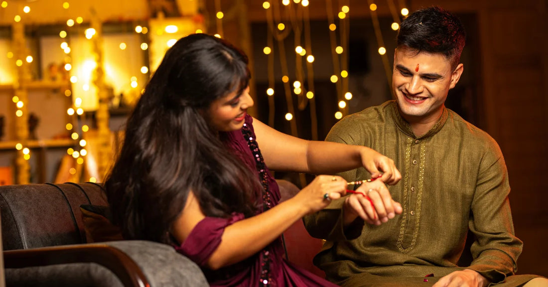 Sister tying a rakhi on her brother's wrist during Raksha Bandhan celebration, representing thoughtful Rakhi gift messages and wishes.