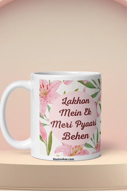 A ceramic mug with a pink floral design with the text 'Lakhon Mein Ek Meri Pyaari Behen' printed on the front, just perfect as a rakhi git for sister.